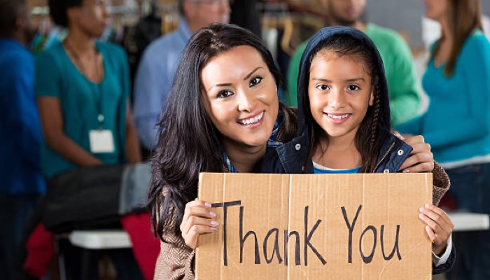 Woman child holding thank you sign